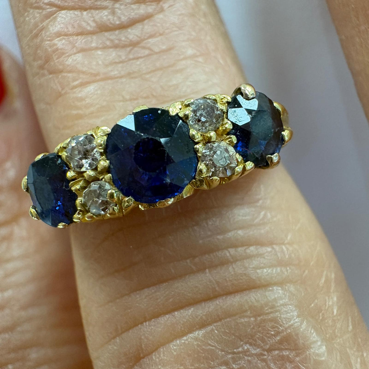 sapphire half hoop ring, carved half hoop ring, antique sapphire ring UK, sapphire and diamond ring, Edwardian sapphire ring, 18ct gold sapphire ring, alternative engagement ring, three stone sapphire ring