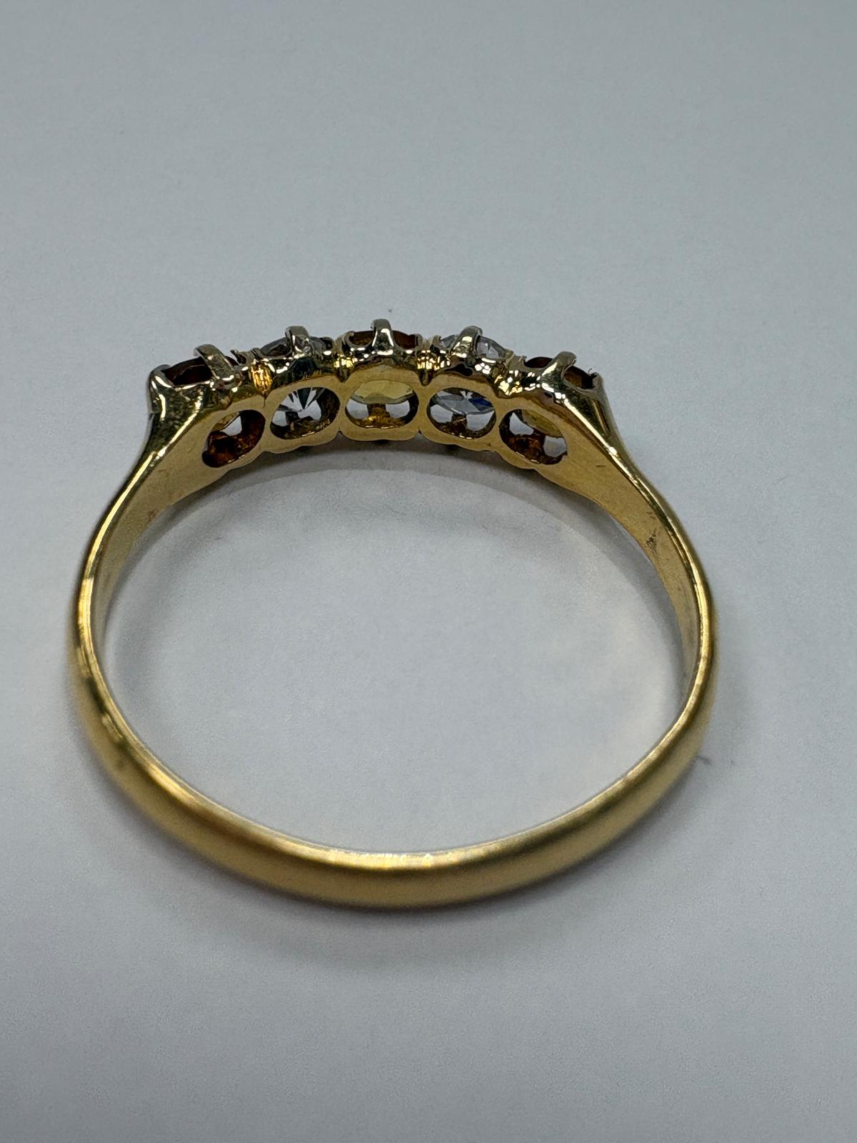 Vintage 18ct yellow gold citrine and white stone five stone graduating ring size S½ with three amber citrines alternating with two white stones in claw setting, shown on white background and worn on finger, available at Fogal & Barnes Harrogate