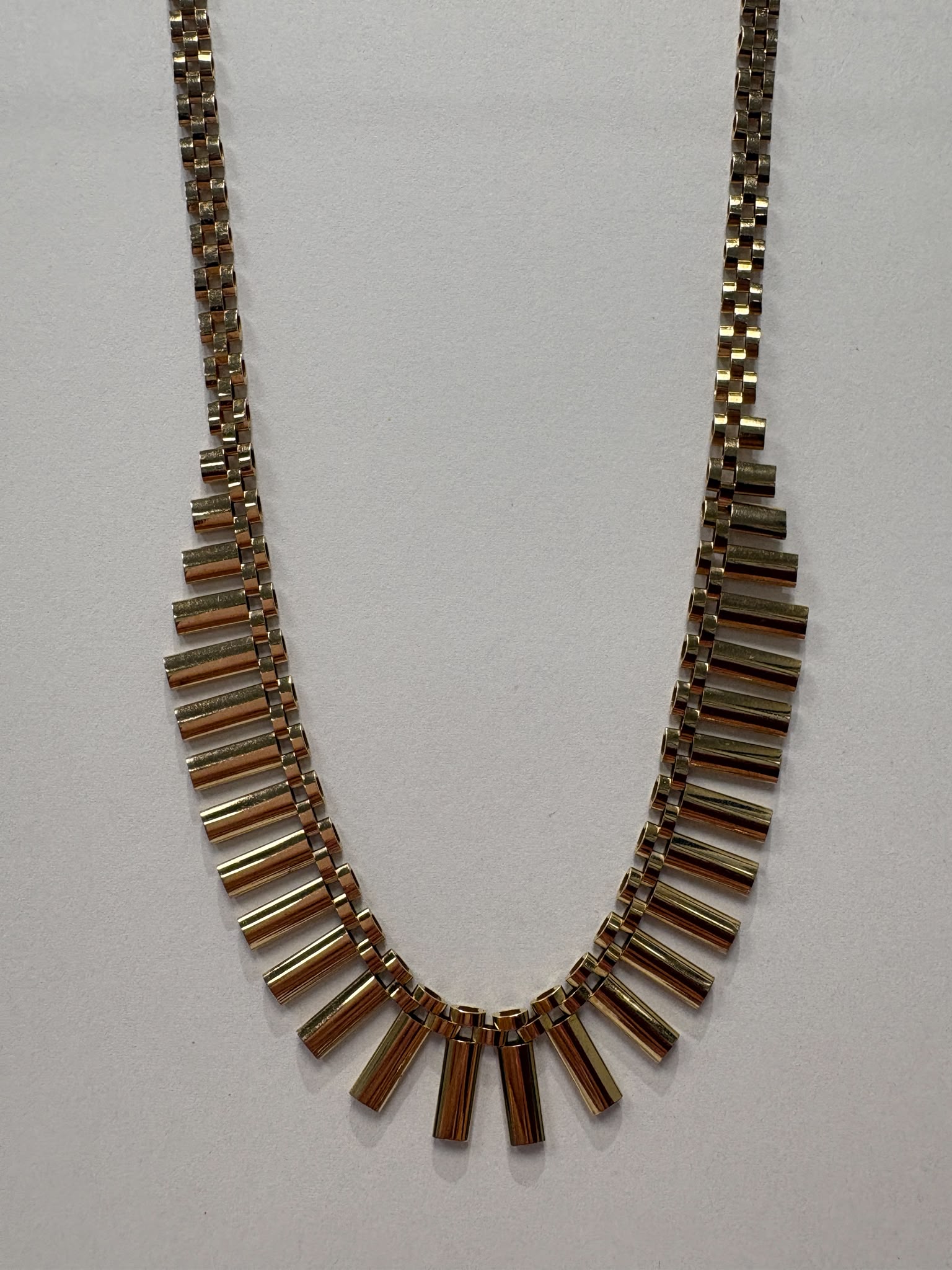 Vintage 1970s 9ct yellow gold graduating fringe necklace with alternating textured and polished cylindrical bars on a brick link chain with safety clasp, 20.50g, shown on white background, available at Fogal & Barnes Harrogate