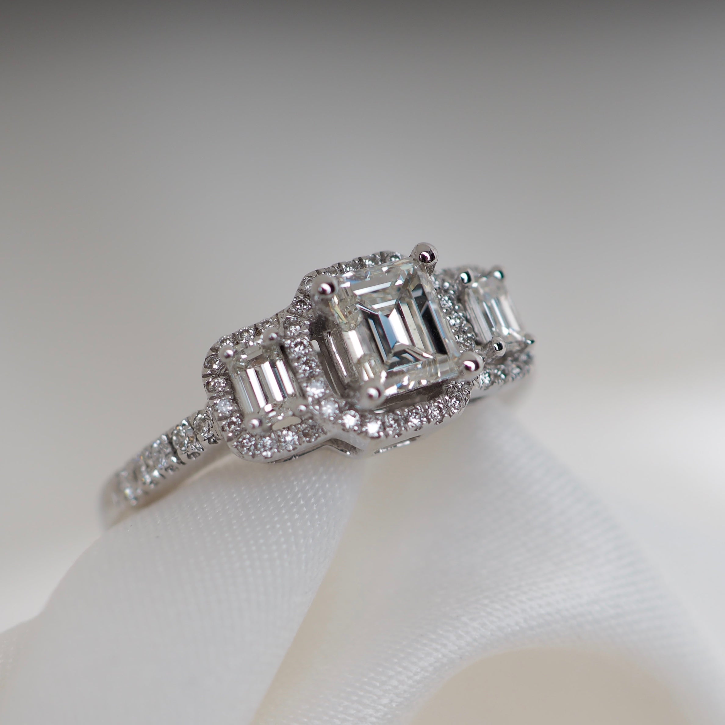 Fancy emerald cut trilogy engagement ring diamond halo white gold Harrogate jewellers Fogal and barnes 